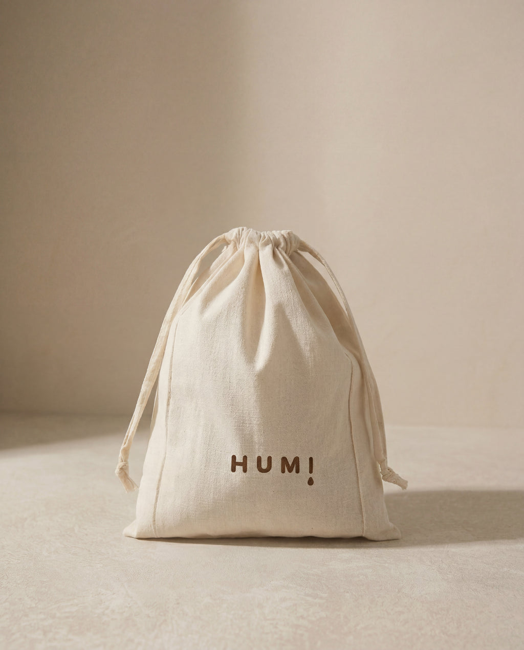 Humi cotton drawstring storage bag standing on a neutral background.