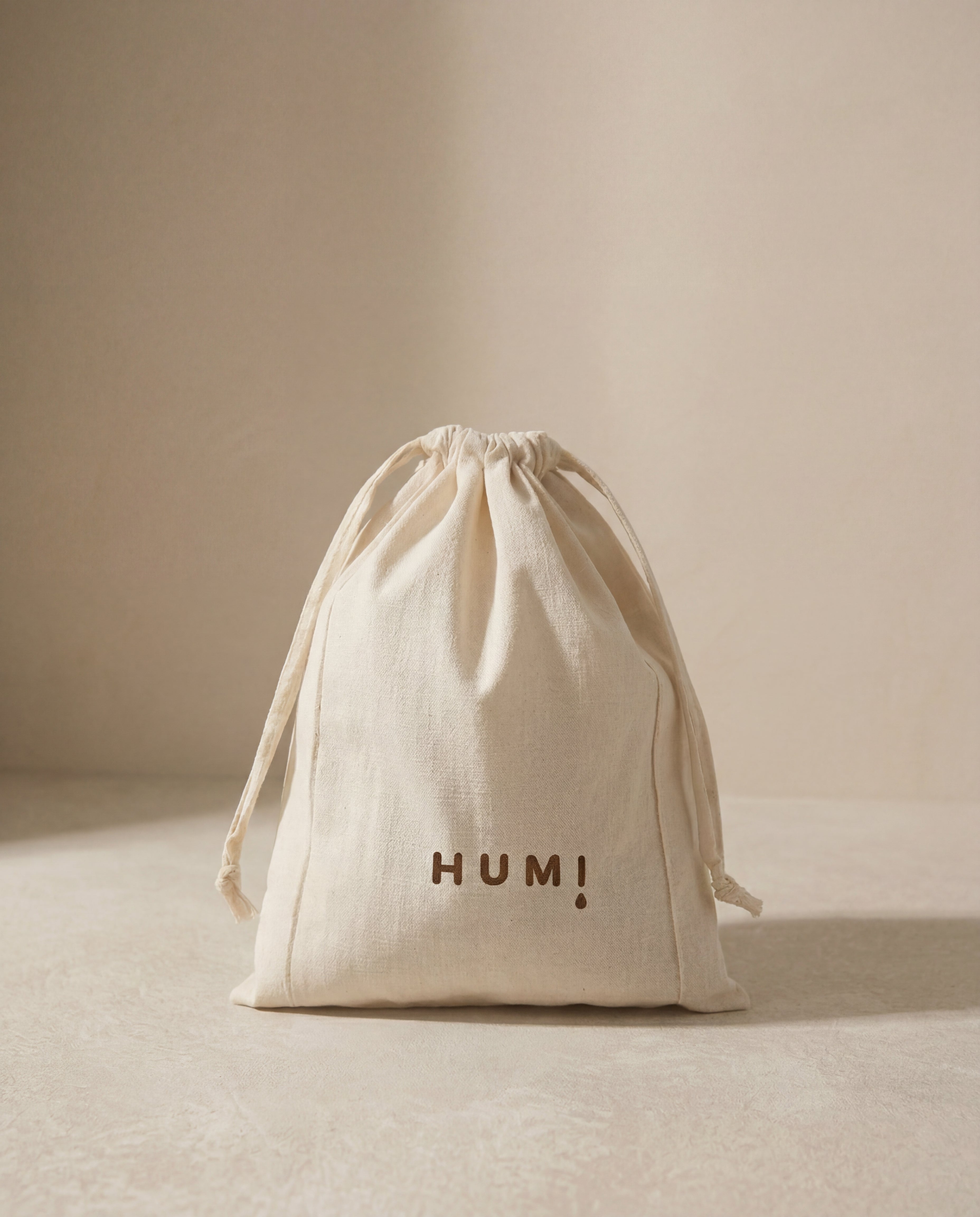Humi cotton drawstring storage bag standing on a neutral background.
